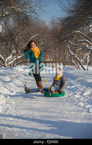 Young lovers having fun in winter clothes in the Park. Christmas Stock Photo