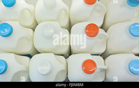 milk bottles on fridge shelf in supermarket store Stock Photo