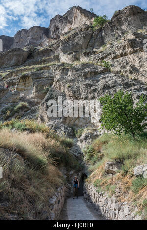 Tourists in cave monastery Vardzia, excavated from the slopes of the Erusheti Mountain, Samtskhe-Javakheti region, Georgia Stock Photo