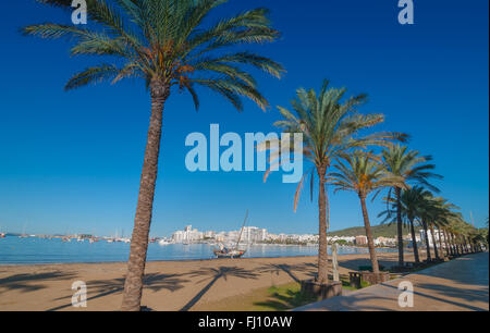 Mid morning sun on Ibiza waterfront.  Warm sunny day along the beach in St Antoni de Portmany Balearic Islands, Spain. Stock Photo