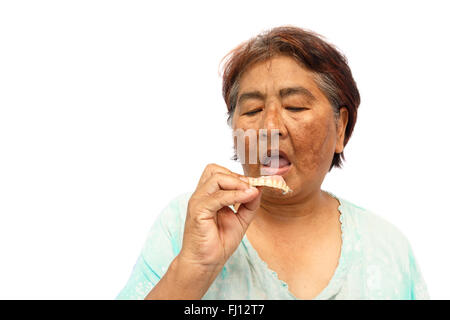 Old hoary woman open mouth and prepare to put a denture ( isolated background )