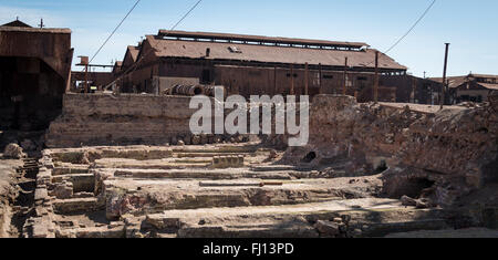 Abandoned industrial buildings and factories at Humberstone ghost, a former nitrate mining town in the Atacama desert. Stock Photo