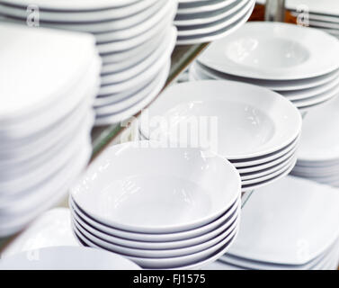 stack of clean white plates on shelf Stock Photo