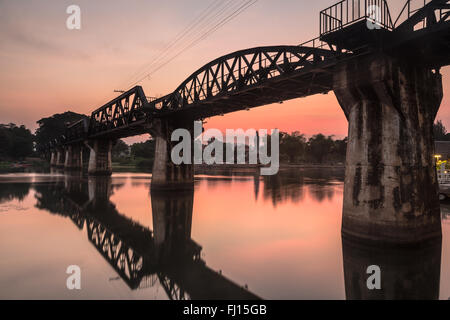 Sunset over the River Kwai bridge in Kanchanaburi, Thailand. The bridge was part of the famous death railways that the Japanses Stock Photo