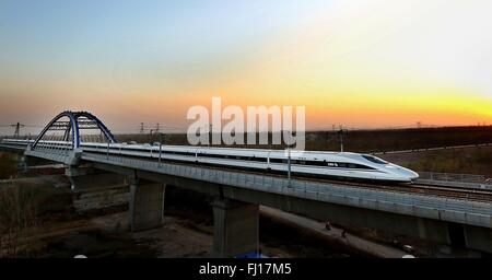 (160228) -- BEIJING, Feb. 28, 2016 (Xinhua) -- File photo taken on Nov. 25, 2012 shows a bullet train running through the Huanghe Bridge on Zhengzhou section of the Beijing-Guangzhou high-speed railway in central China's Henan Province. 'Building more high-speed railways' has been a hot topic at the annual sessions of China's provincial legislatures and political advisory bodies intensively held in January. China has the world's largest high-speed rail network, with the total operating length reaching 19,000 km by the end of 2015, about 60 percent of the world's total. The expanding high-spee Stock Photo