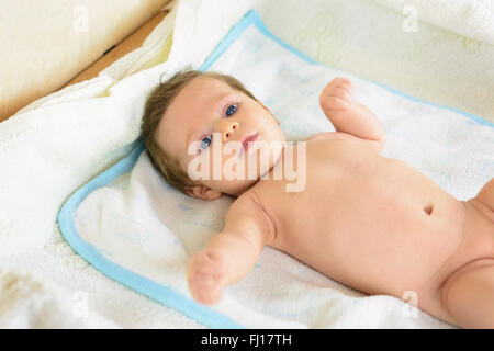 A Infant lying on a white towel . Stock Photo