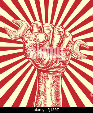 An original design of a fist hand holding a spanner in a vintage propaganda poster wood cut style Stock Photo