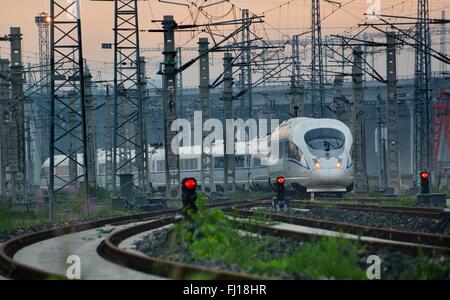 (160228) -- BEIJING, Feb. 28, 2016 (Xinhua) -- File photo taken on June 30, 2015 shows a bullet train running southbound to Shanghai's Hongqiao Railway Station. 'Building more high-speed railways' has been a hot topic at the annual sessions of China's provincial legislatures and political advisory bodies intensively held in January. China has the world's largest high-speed rail network, with the total operating length reaching 19,000 km by the end of 2015, about 60 percent of the world's total. The expanding high-speed rail network is offering unprecedented convenience and comfort to traveler Stock Photo