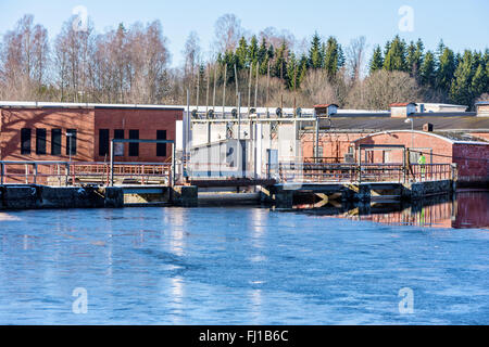 Fridafors, Sweden - February 16, 2016: Unknown person doing a security check on an abandoned paper mill at the bridge of a dam. Stock Photo