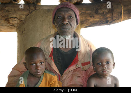 Portrait of Dogon chief with his grandchildren in Dogon country, Mali Stock Photo