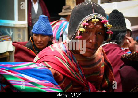 Man in Tarabuco market wearing Spanish conquistadors helmet, Bolivia Stock Photo