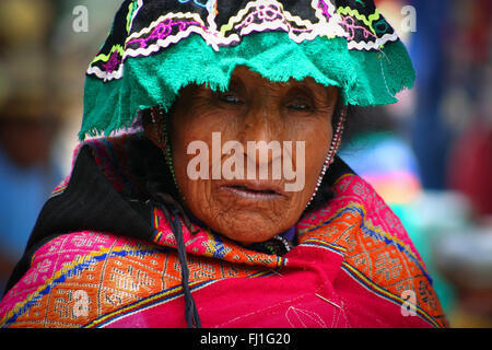 Portrait of Peruvian woman with traditional outfit and hat in Pisac market, Peru Stock Photo