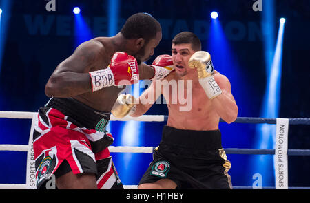 Halle, Germany. 27th Feb, 2016. Marco Huck (R, Germany) and Ola Afolabi (Great Britain) fight during the cruiserweight boxing match at the IBO World Championships in Halle, Germany, 27 February 2016. Marco Huck won in the 10th round. Photo: GUIDO KIRCHNER/dpa/Alamy Live News Stock Photo