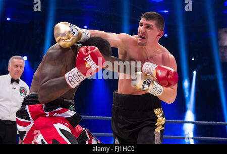 Halle, Germany. 27th Feb, 2016. Marco Huck (R, Germany) and Ola Afolabi (Great Britain) fight during the cruiserweight boxing match at the IBO World Championships in Halle, Germany, 27 February 2016. Marco Huck won in the 10th round. Photo: GUIDO KIRCHNER/dpa/Alamy Live News Stock Photo