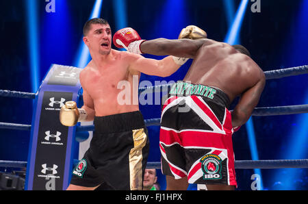 Halle, Germany. 27th Feb, 2016. Marco Huck (L, Germany) and Ola Afolabi (Great Britain) fight during the cruiserweight boxing match at the IBO World Championships in Halle, Germany, 27 February 2016. Marco Huck won in the 10th round. Photo: GUIDO KIRCHNER/dpa/Alamy Live News Stock Photo