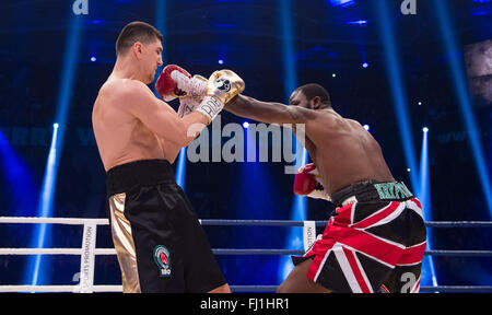 Halle, Germany. 27th Feb, 2016. Marco Huck (L, Germany) and Ola Afolabi (Great Britain) fight during the cruiserweight boxing match at the IBO World Championships in Halle, Germany, 27 February 2016. Marco Huck won in the 10th round. Photo: GUIDO KIRCHNER/dpa/Alamy Live News Stock Photo
