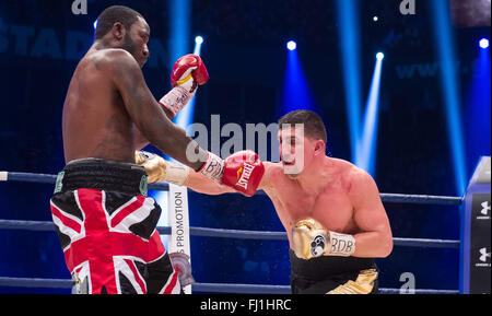 Halle, Germany. 27th Feb, 2016. Marco Huck (R, Germany) and Ola Afolabi (Great Britain) fight during the cruiserweight boxing match at the IBO World Championships in Halle, Germany, 27 February 2016. Marco Huck won in the 10th round. Photo: GUIDO KIRCHNER/dpa/Alamy Live News Stock Photo