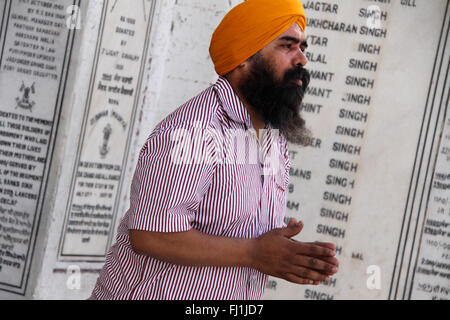 Sikh man praying with turban in Golden temple, Amritsar , India Stock Photo