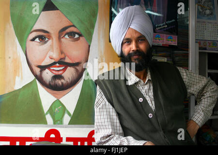 Punjabi Sikh man with Sikh man painting in Amritsar , India Stock Photo
