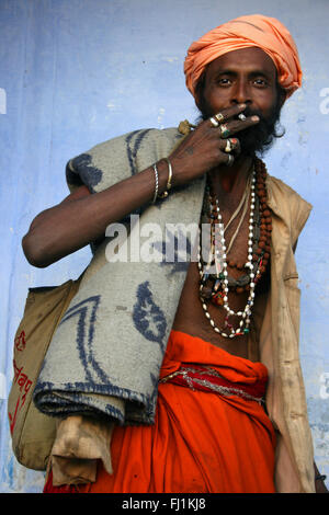 Sadhu / Hindu holy man smoking in Pushkar , India Stock Photo