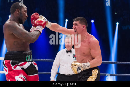 Halle, Germany. 27th Feb, 2016. Marco Huck (R, Germany) and Ola Afolabi (Great Britain) fight during the cruiserweight boxing match at the IBO World Championships in Halle, Germany, 27 February 2016. Marco Huck won in the 10th round. Photo: GUIDO KIRCHNER/dpa/Alamy Live News Stock Photo