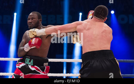 Halle, Germany. 27th Feb, 2016. Marco Huck (R, Germany) and Ola Afolabi (Great Britain) fight during the cruiserweight boxing match at the IBO World Championships in Halle, Germany, 27 February 2016. Marco Huck won in the 10th round. Photo: GUIDO KIRCHNER/dpa/Alamy Live News Stock Photo