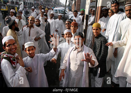 A group of happy and smiling Muslim guys with traditional costumes stand in a street of Jodhpur, India Stock Photo