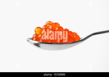Silver spoon full of trout caviar on white background Stock Photo