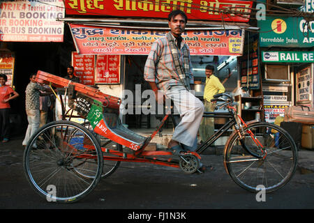 Cyclo Rickshaw driver in a street in Delhi, India Stock Photo