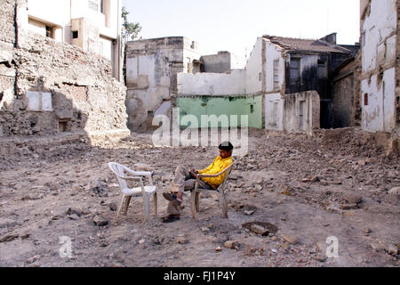Man sits alone in the ruins of destroyed building after earthquake in Bhuj, Gujarat,  in India Stock Photo