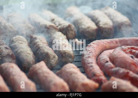 Barbecuing meat on charcoal fire closeup image. Stock Photo