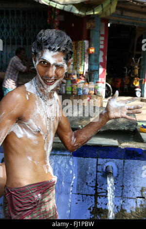 Happy young man covered with soap while washing in Kolkata , India Stock Photo