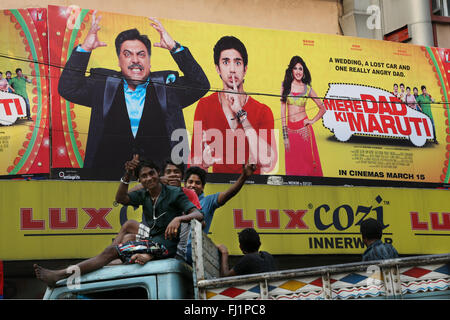 Young Indian guys say hello from the top of a truck in Kolkata , India Stock Photo