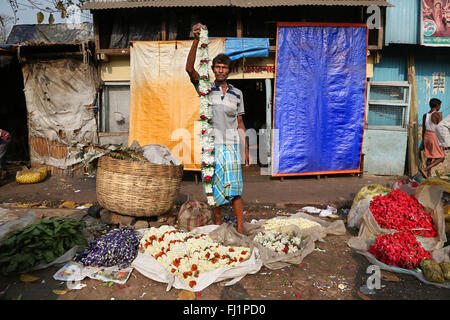 Flower seller at the Kolkata Mullick ghat flower market , India Stock Photo