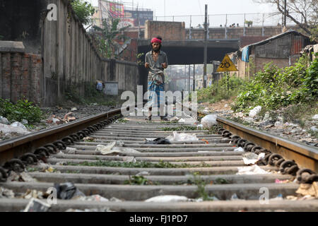 Man stands alone on train rails in Howrah , Kolkata, India Stock Photo