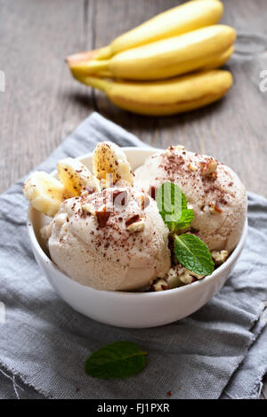 Banana ice cream in bowl on country table Stock Photo