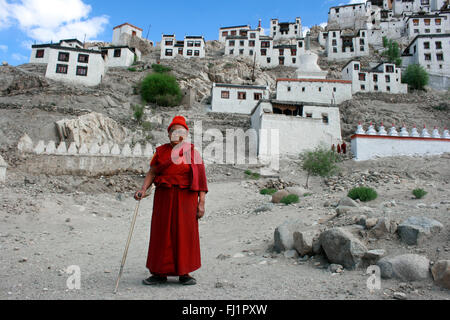 Buddhist nun in front of Thiksey Monastery , Ladakh , India Stock Photo