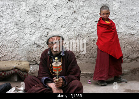 Old man and young monk during celebrations at Hemis monastery gompa near Leh in Ladakh, India Stock Photo