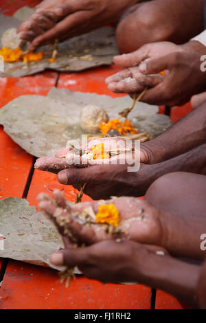 Hands of people making puja ceremony in Haridwar during Kumbh mela 2010 Stock Photo