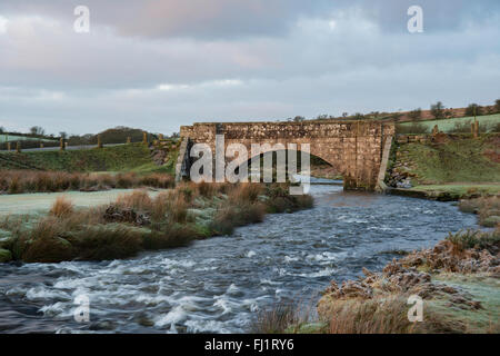 Cadover Bridge over the River Plym in the Dartmoor National Park. Taken on a frosty winter morning just after Sunrise. Stock Photo