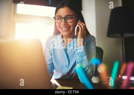 closeup business woman working at office sunlight in back warm look Stock Photo