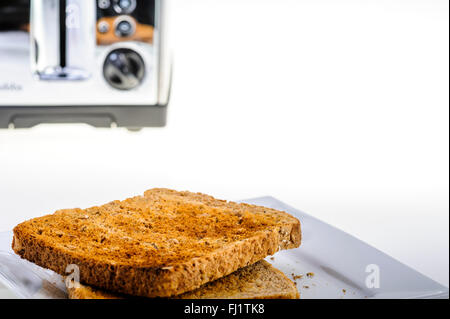 Two freshly slices of toast waiting to be buttered. Stock Photo