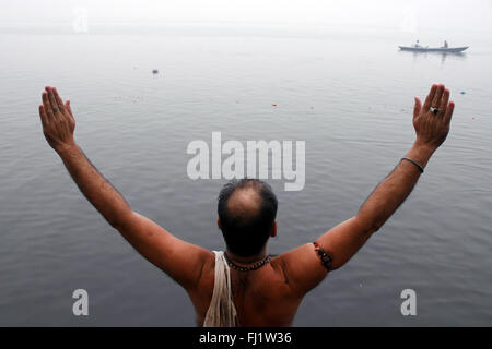 People praying on the banks of the Ganges in Varanasi , India Stock Photo