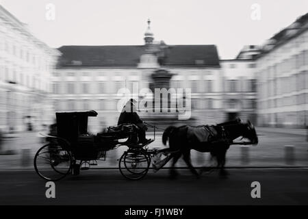 Horse-driven carriage at Hofburg palace in Vienna, Austria, black/white Stock Photo