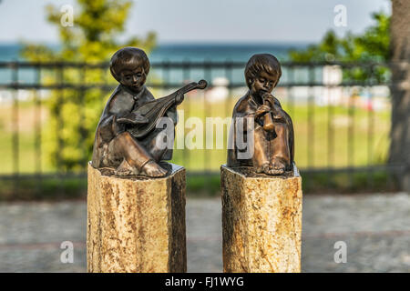 The bronze sculptures lute player and flute player located at the beach promenade from Binz, Ruegen Island, Germany, Europe Stock Photo