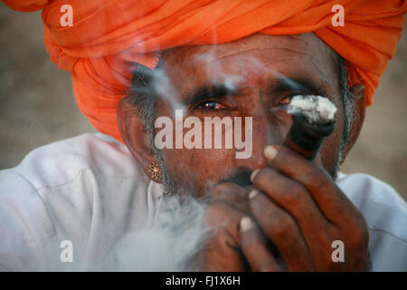 Portrait of Indian Rajasthan Rajasthani hindu man during Pushkar mela-  Pushkar camel fair in Rajasthan, India Stock Photo