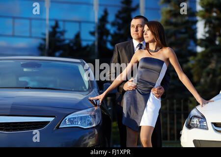 young couple standing near the car Stock Photo