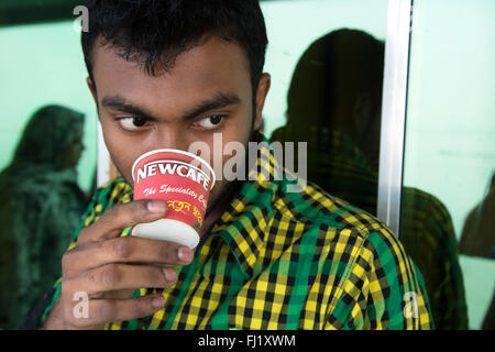 Bangladesh man drinking Newcafé beverage inspired by Nescafé traditional brand , Dhaka Stock Photo