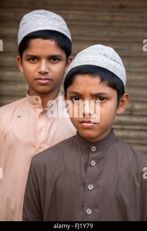 Portrait of Muslim kids with Taqiyah (cap) and traditional dress in Dhaka, Bangladesh Stock Photo