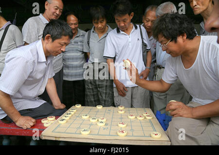 Group of men playing chess in the Temple of Heaven Park , Beijing , China Stock Photo
